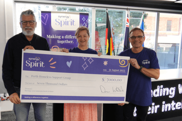 Perth Homeless Support Group Chairperson Simon Lane receiving a cheque from Executive General Manager Tiri Sanderson and Synergy Spirit President Darren Walters